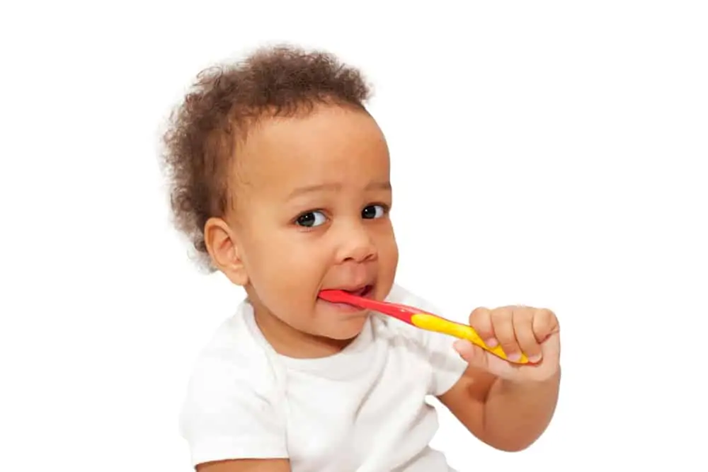 Toddler brushing their teeth