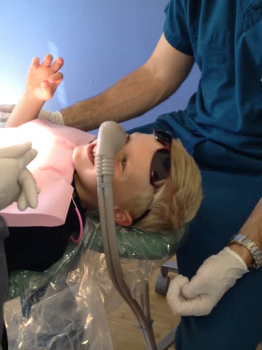 Child in dentist office receiving nitrous oxide